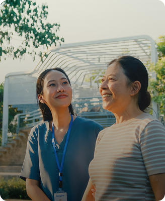 Healthcare worker with senior woman smiling outdoors